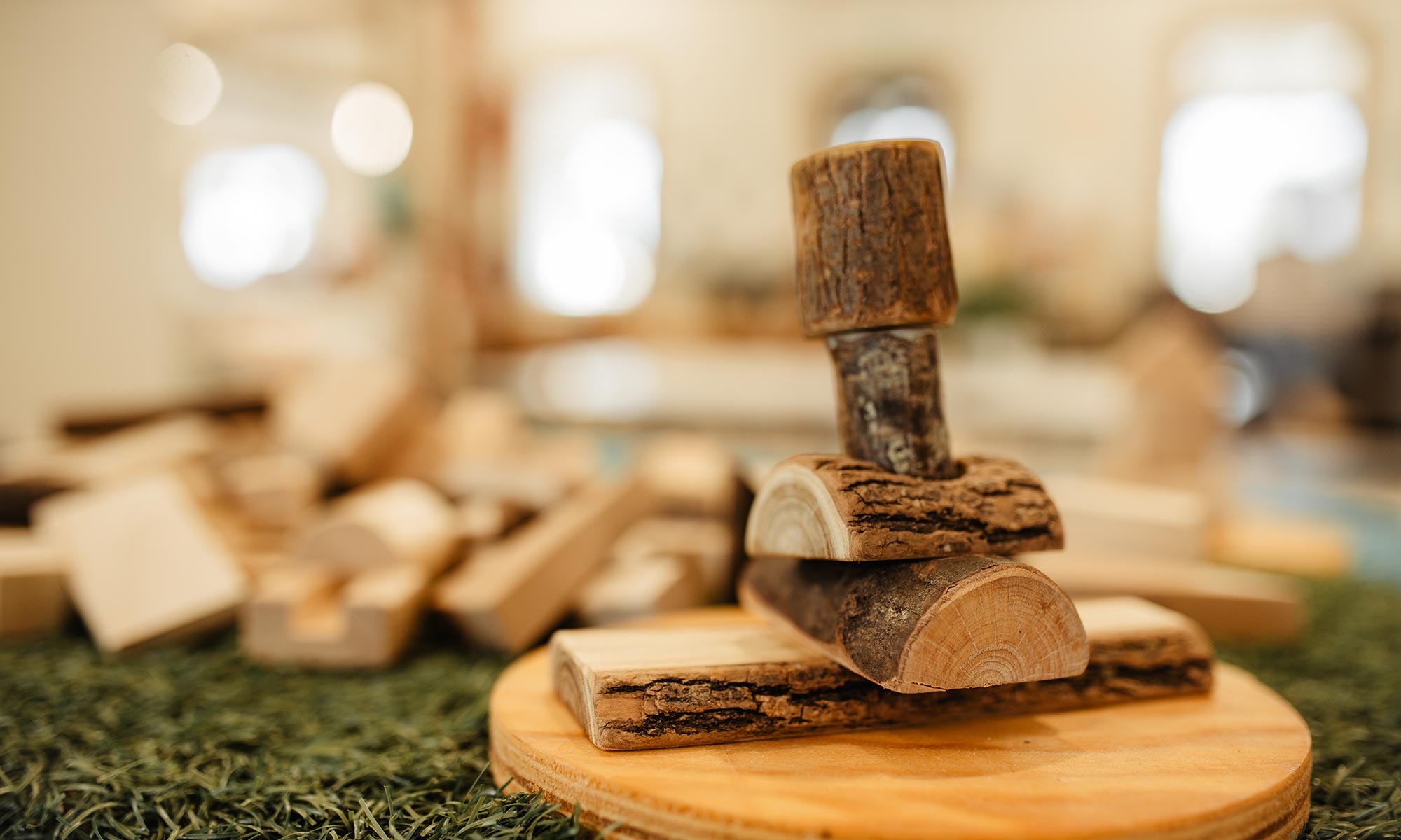 A wooden stacking toy on a round board