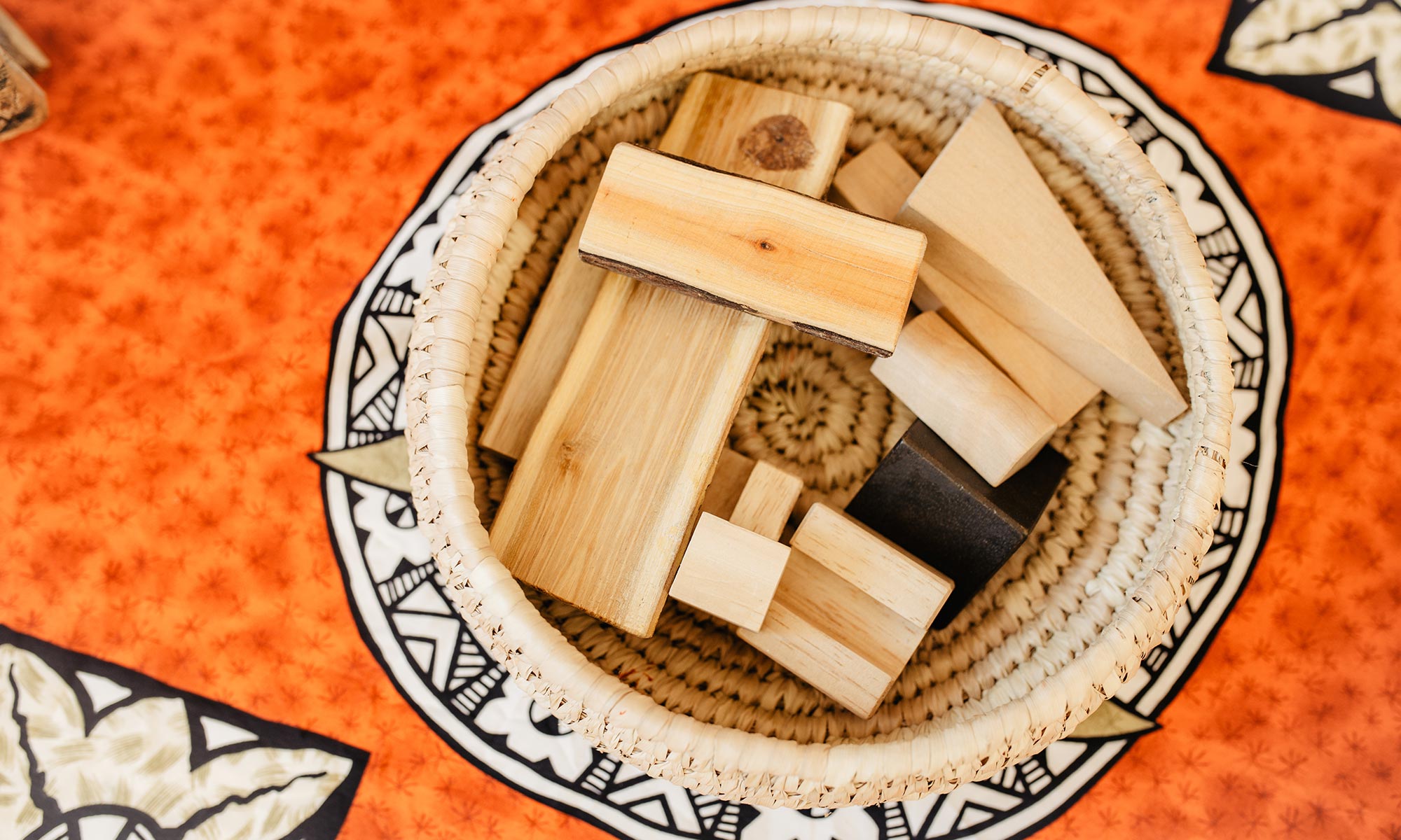 A woven basket filled with wooden blocks